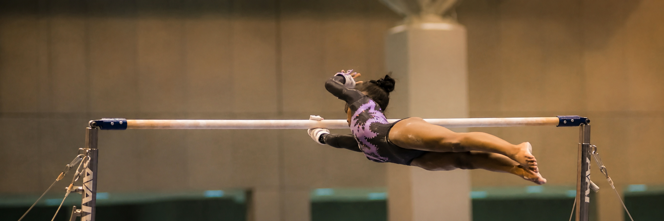 Rhegan Duncombe competing on the uneven bars as a young gymnast